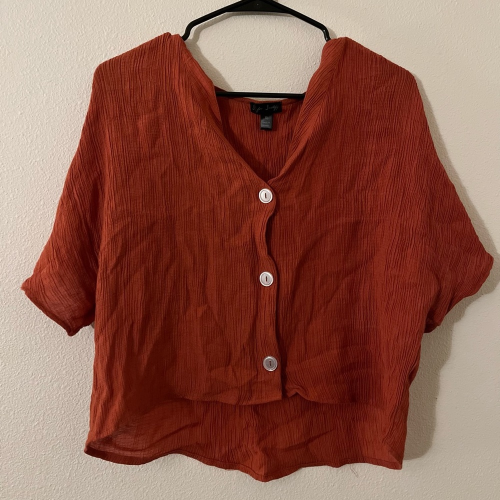 Cute orange crop topped with texture.